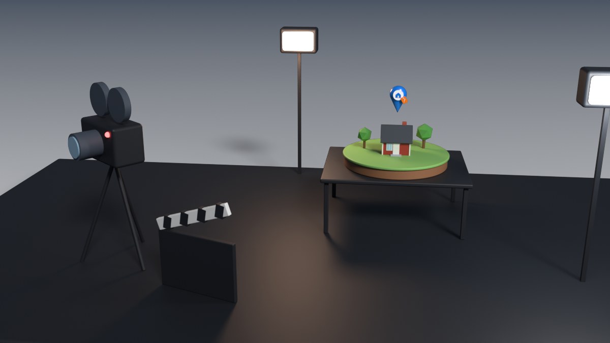 A film camera on a tripod films a tiny diorama of a house under studio lights