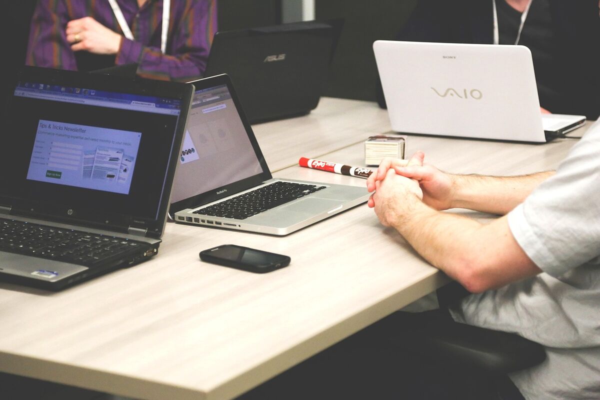 A team working around laptops at an office table