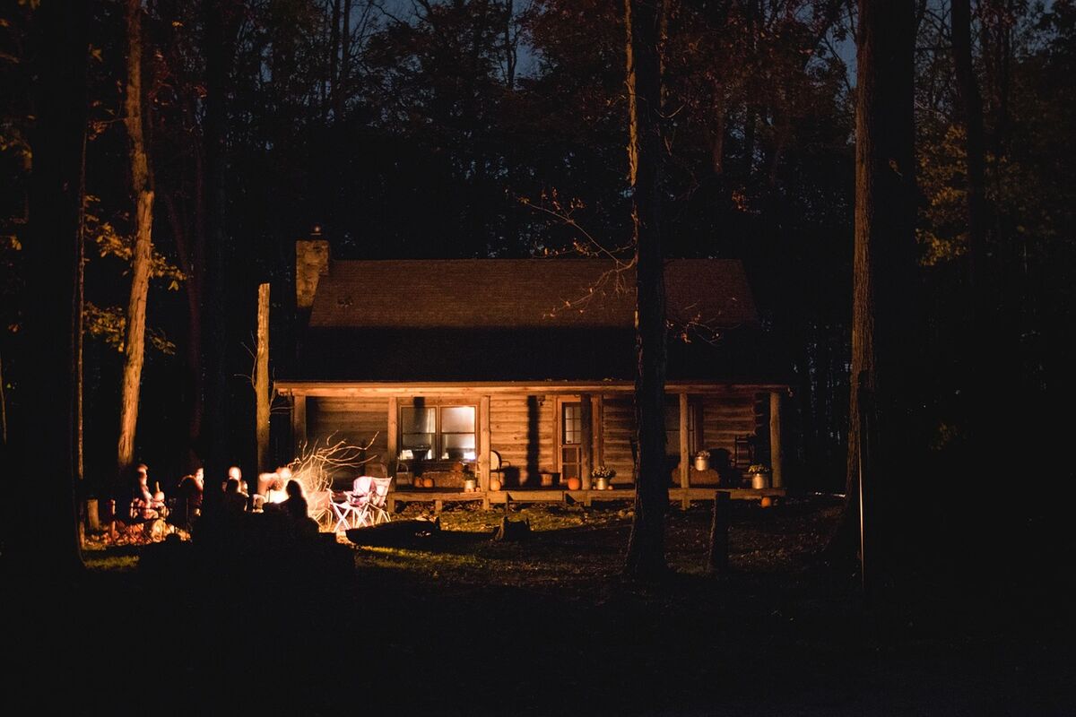 Friends gathered around a campfire at night