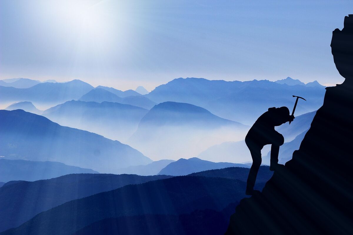A climber standing on a mountain summit