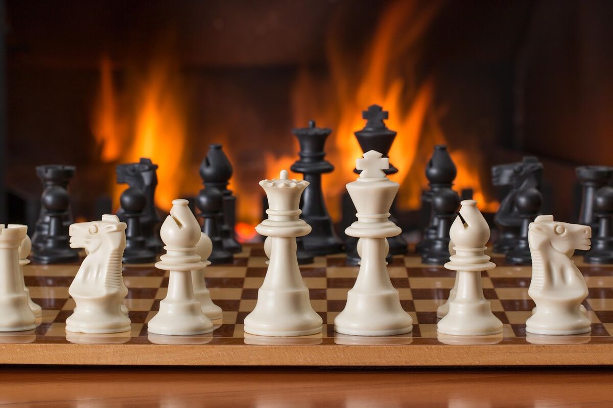 Chess pieces lined up on a board