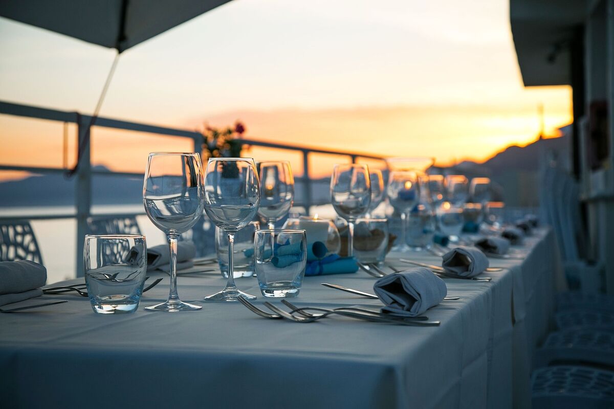 A long dinner table set at sunset