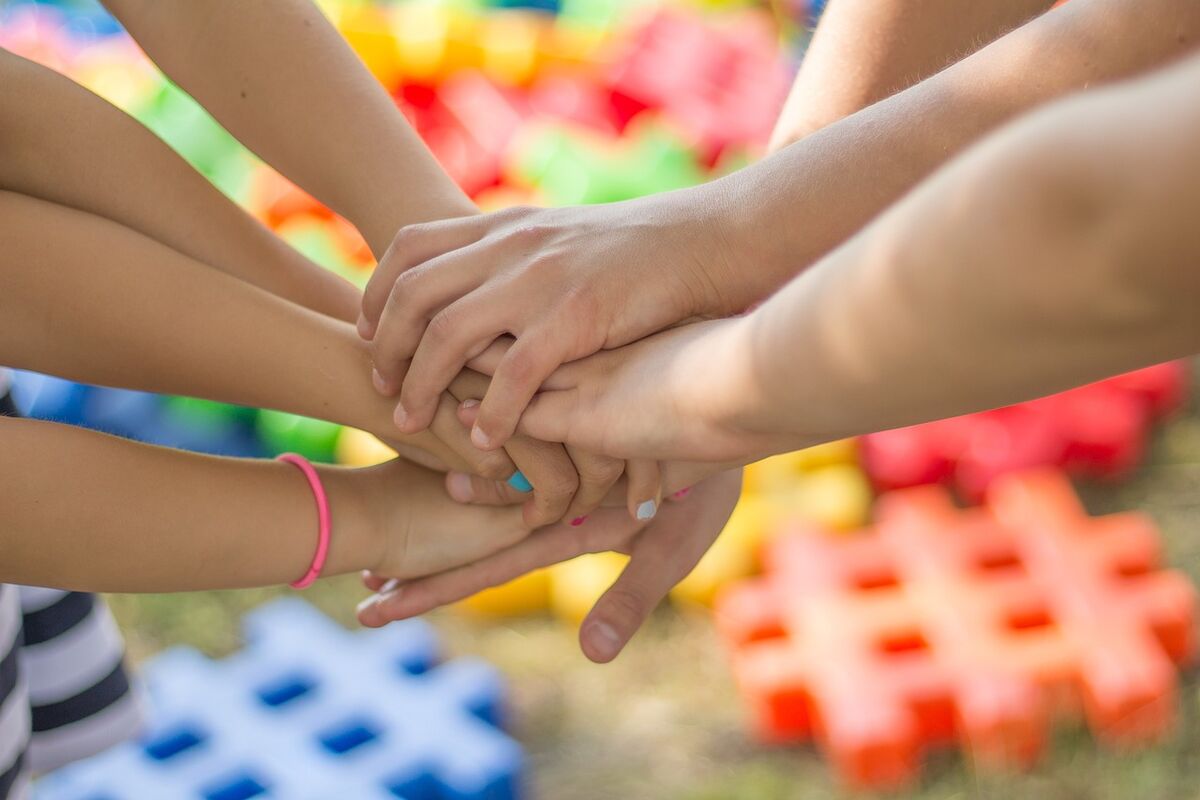 Hands stacked together in a team huddle